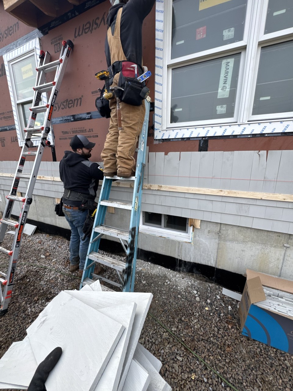 Woodland crew performing quality siding installation